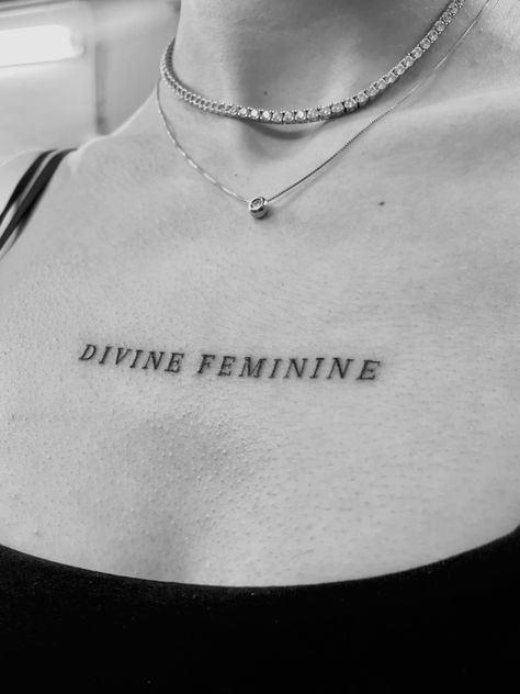 Chest Feminine Tattoo, Text Tattoo On Chest Woman, Writing Arm Tattoos For Women, Divine Feminine Tattoo Collarbone, Simple Chest Tattoos For Women, Small Girly Neck Tattoos, Divine Feminine Word Tattoo, Feminine Sign Tattoo, 26 Tattoo Number Ideas