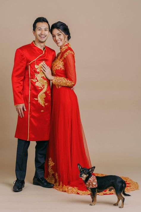 Go classy and sophisticated with this traditional red and gold wedding ao dai. With intricate gold embroidery details thoughtfully placed from top to bottom, you'll look and feel regal in this traditional Vietnamese bridal gown whether you're rocking your tea ceremony or taking photos and greeting guests afterward. Check out additional dresses at www.eastmeetsdress.com. Groom's outfit recommendation: Pair this with our Nguyen Jacket. Accessory recommendation: Pair this with our Blossom Hairpin. Chinese Wedding Favors, Traditional Vietnamese Wedding, Vietnamese Wedding Dress, Wedding Dress Traditional, Tea Ceremony Dress, Vietnamese Wedding, Dress Traditional, Wedding Jacket, Groom Looks