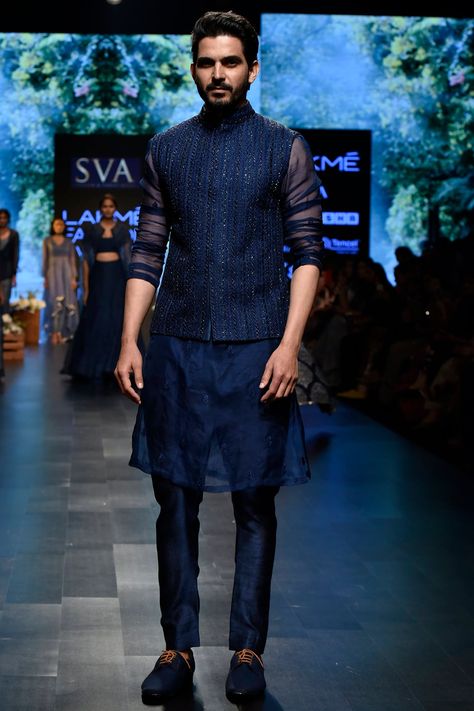 Featuring a midnight blue bundi jacket in raw silk base with cutdana and thread work embroidery. It is paired with a contrasting blue kurta in organza base and pants.    FIT: True to size.  COMPOSITION: Raw silk, Organza.  CARE: Dry clean only. Jacket Outfits Men, India Fashion Men, Thread Work Embroidery, Kurta Pants, Mens Indian Wear, Wedding Kurta For Men, Groom Dress Men, Indian Groom Wear, Wedding Dresses Men Indian