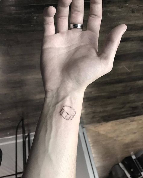 Minimalist drum tattoo on the inner wrist. Simple Drum Tattoo, Small Drum Tattoo, Drum Tatoos, Drum Tattoo Ideas For Women, Percussion Tattoo, Drum Set Tattoo, Drums Tattoo Ideas, Drummer Tattoo Ideas, Drum Tattoo Ideas