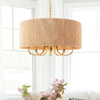 This 5-light chandelier features a handmade paper rope lampshade for a breezy, coastal look over your living room or kitchen island. Its sleek wrought iron frame showcases a gleaming gold finish that's sure to grab glances, and it comes with swooping arms that curve underneath the shade for a candelabra-inspired feel. This chandelier aims to light all around your space from five bulbs up to 60W, which are all sold separately. It hangs from a slim downrod and a sloped-ceiling-compatible canopy. P Kitchen Table Chandelier, Paper Chandelier, Wheel Chandelier, Iron Accents, Geometric Chandelier, 5 Light Chandelier, Dressing Mirror, Drum Chandelier, Metal Candle Holders