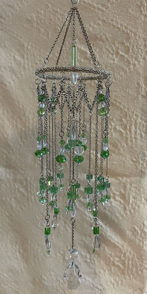 This Chandelier Sun Catcher is made with silver chain and green and clear crystal beads.  This is to be appreciated indoors in front a window where the sun comes in.  The beads glisten in the sunshine and some put out beautiful reflections.  These make great gifts. Beaded House Decor, Crystal Beaded Curtains Doorway, Pendant Display Ideas, Crystal Suncatchers Diy Sun Catcher, Diy Bead Chandelier, Sun Catchers Diy How To Make, Bead Suncatcher Diy, Hanging Crystals Diy, Bead Spiders