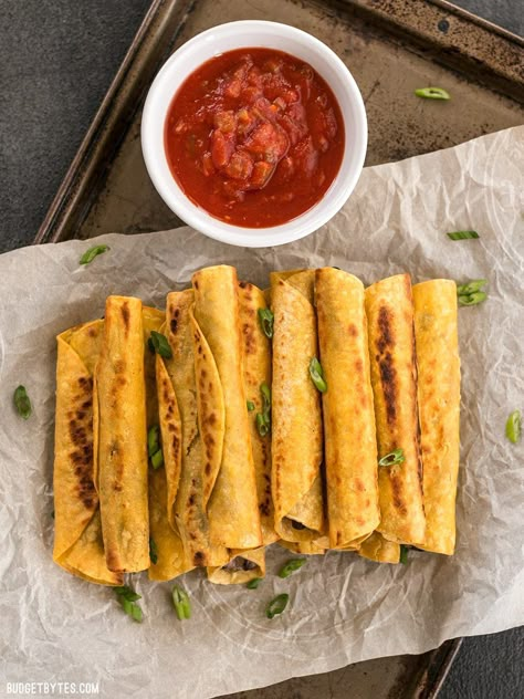 Creamy Black Bean Taquitos are an easy and tasty party treat for football games or just for fun! BudgetBytes.com Black Bean Taquitos, Inexpensive Appetizers, Bean Taquitos, Budget Bytes, How To Cook Beans, Cooking On A Budget, Meatless Meals, Bean Recipes, Cheap Meals