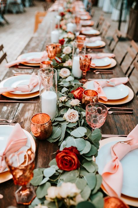 Eucalyptus table runner with floral accents of burnt orange and peach roses and ranunculus. Nashville wedding floral designer. Orange Floral Centerpiece Wedding, Runner For Wedding Tables, Fall Color Centerpieces, Burnt Orange Table Centerpiece, Peach And Copper Wedding, Eucalyptus And Burnt Orange Wedding, Orange And Green Table Decor, Ranunculus Wedding Decoration, Eucalyptus And Orange Wedding