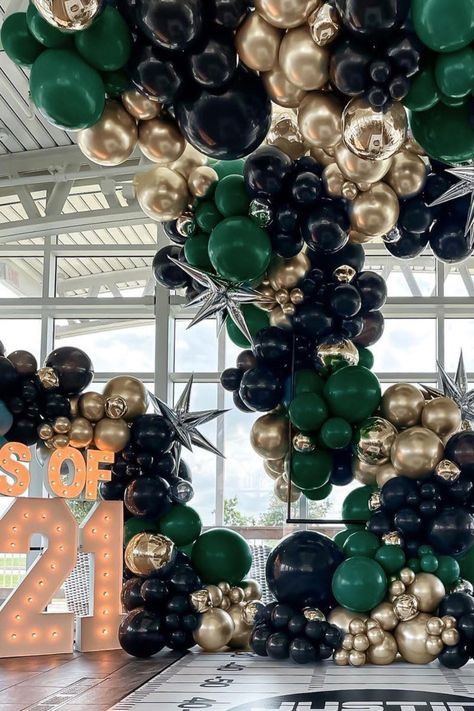 Create a show-stopping display for your graduation party with this luxurious balloon arch in black, gold, and emerald green. Enhanced with shiny silver star accents, this stylish decor is perfect for making a bold statement at any celebration. Whether as a backdrop for photos or a dramatic entrance piece, this balloon arrangement is ideal for elevating your Class of 2021 party or any milestone event with a modern and glamorous touch! Green Gold Balloon Garland, Balloon Arrangement, Green Balloons, 40th Birthday Party Decorations, Black And Gold Balloons, Dramatic Entrance, Balloon Arrangements, Garland Arch, Green Balloon