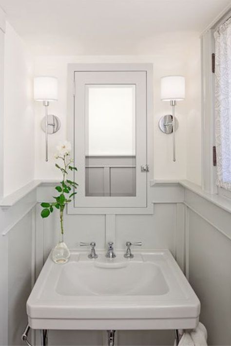 Seapearl by Benjamin Moore is the white color above the paneled wainscot in this powder room while Stonington Gray is the paint color on trim. #powderroom #paintcolors #benjaminmooreseapearl #benjaminmoorestoningtongray #seapearl #stoningtongray Painted Wainscoting, Amber Interiors Design, Bad Inspiration, Powder Room Design, Amber Interiors, Bathroom Renos, Joanna Gaines, Beautiful Bathrooms, Raised Beds