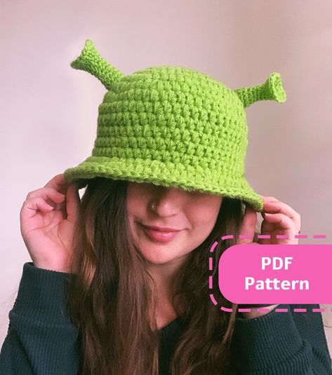 The best accessory for a believer could ever crochet - the Shrek Bucket Hat by Lala Crochet!  with this easy, step by step accompanied by photos and demonstrations you could have your own Shrek hat in 1 day!  Tools & Materials needed for this project:  - 2 skeins of size 4 acrylic/cotton yarn in light green - 4mm hook (G-6) - 5mm hook (H-8) - Scissors  - Stitch markers - Darning needle Crochet Novelty Hats Free Pattern, Shrek Bucket Hat Crochet Pattern, Crochet Wig Hat, Shrek Hat Crochet Pattern, Shrek Crochet Hat, Crochet Audrey 2, Silly Crochet Hats, Crochet Shrek Hat, Crochet Shrek