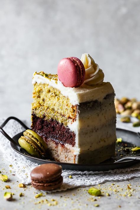 This exquisite Italian Spumoni Cake showcases a delicious trio of strawberry, chocolate and pistachio layered cake. It is crowned with elegantly swirled buttercream and topped with macaron cookies, creating a visibly stunning dessert. Bake Off Cakes Ideas, Pistachio Crepe Cake, Crazy Cake Flavors, Pistachio Strawberry Cake, Deluce Cakes, Cool Cake Recipes, Layer Cake Ideas, Spumoni Cake, Chocolate Pistachio Cake