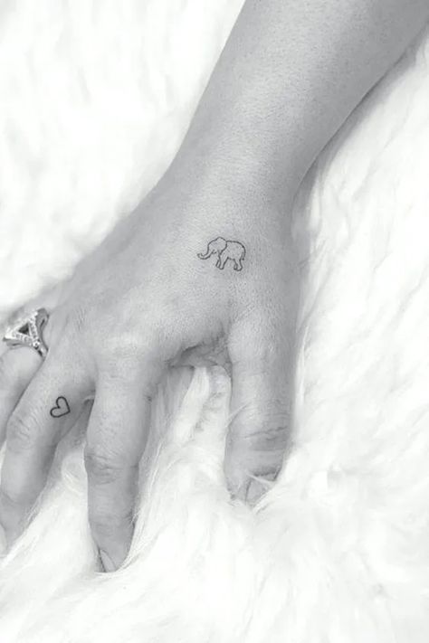 Tiny elephant and heart girly side of hand tattoo designs Elephant Finger Tattoo, Elephant Tattoo On Hand, Little Elephant Tattoos, Tatuaje Studio Ghibli, Tiny Elephant Tattoo, Side Hand Tattoos, Tattoos Animals, Tato Minimal, Tiny Wrist Tattoos