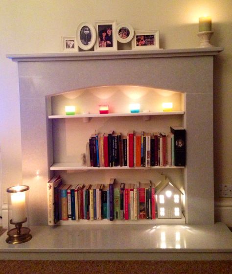 Books In Fireplace, Converted Fireplace, Book Fireplace, Fireplace With Candles, Focal Point Living Room, Candles And Books, Fireplace Bookshelf, Compact Living Room, Clothes Shelves