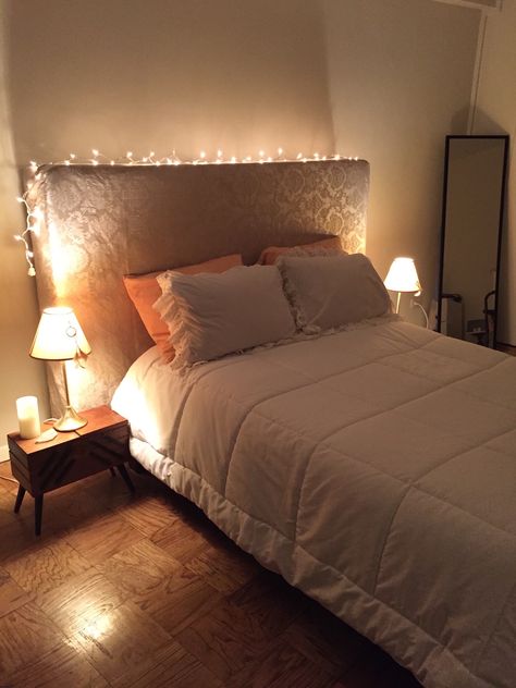 I decided to use the box spring as a headboard. Covered it with a lovely brocaded fabric and put Xmas lights for a special effect. Headboard Lights Ideas, Headboard Fairy Lights, Fairy Lights On Headboard, Fairy Lights Headboard, Cozy Small Bedroom Decor, Light Decor Ideas, Bed Lighting, Dorm Room Colors, Farmhouse Headboard