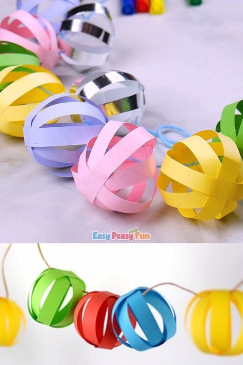 This paper ball garland craft is perfect as a Christmas decoration and it will also look absolutely adorable at any birthday party (any time of the year). Garland Craft, Paper Ball, Paper Balls, Christmas Decorations For Kids, Ball Garland, Seni Dan Kraf, Christmas Paper Crafts, Kraf Diy, Easy Christmas Crafts