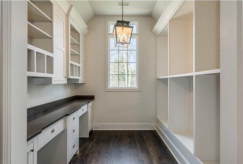 Cottage butler's pantry features a carriage lantern illuminating a wall of modular units facing side by side built-in desks topped with black quartz placed under open shelving and pigeon hole cubbies. Pantry With Desk Built Ins, Butler Pantry With Desk Area, Butlers Pantry With Desk, Barndo Pantry, Pantry With Desk, Hall Pantry, Pantry Desk, Pantry Features, Pantry Unit