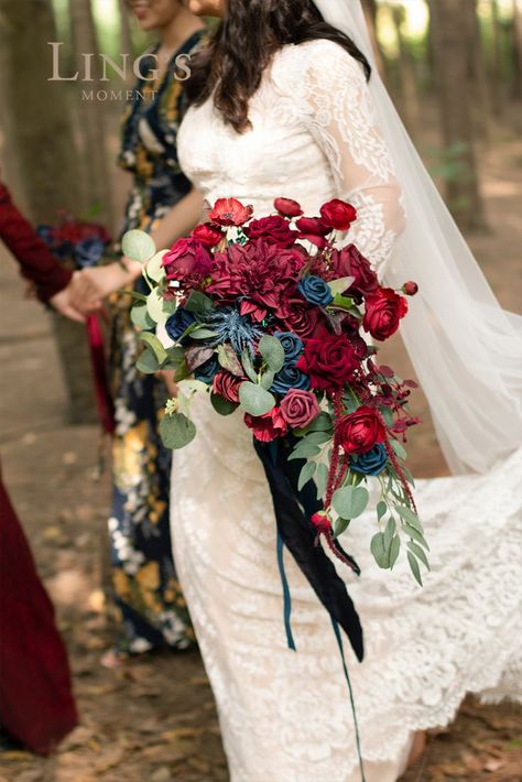 Luxury jewel tone color palette - burgundy, dark red, and navy. This deluxe bridal bouquet will accentuate the romance and sanctity of your wedding! Perfect for a vintage wedding ceremony, bridal shower, dinner as a bridal bouquet. #BridalBouquet #Bouquet #WeddingBouquet #WinterWedding #WeddingIdeas #DIYWedding #RusticWedding #Wedding #WeddingDecor #WeddingFlower #Weddingreception #NavyWedding #BurgundyWedding #RedWedding Navy Wedding Decor, Navy Blue Wedding Decorations, Burgundy And Navy Wedding, Natural Bridal Bouquet, Vintage Wedding Ceremony, Jewel Tone Color Palette, Blue Wedding Decorations, Cascading Bridal Bouquets, Large Flower Arrangements