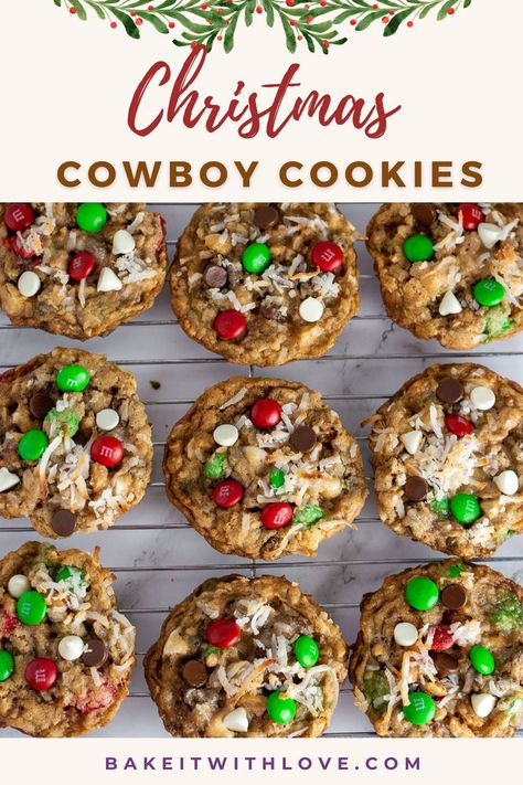 An overhead shot of rows of soft and chunky Cowboy cookies loaded with green and red M&Ms, coconut, chocolate chips, white chocolate chips, and more. Cowboy Cookie Recipe, Chewy Oatmeal Cookies, Cookies Chewy, Christmas Cookie Recipes Holiday, Holiday Baking List, Baking List, Christmas Cowboy, Cowboy Cookies, Christmas Baking Recipes