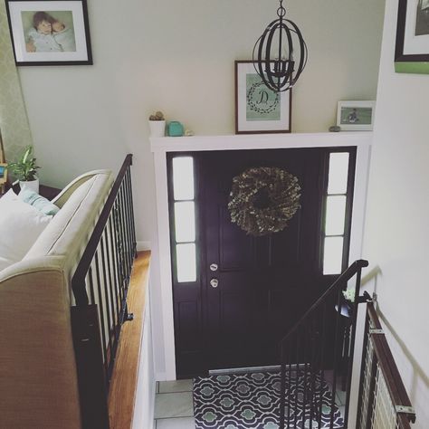 split level entryway, black door, white trim, globe light, modern farmhouse Split Level Entryway Light Fixture, Split Level Entrance Ideas, Bilevel Entryway Split Entry, Split Level Entry Remodel, Split Foyer Decorating, Split Level Entryway Ideas, Front Door Interior Entryway, Split Foyer Entry, Entryway Ideas Small