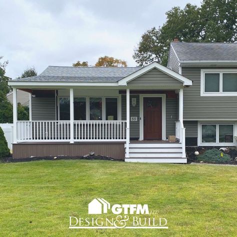 Work is finishing up on this covered front porch in Pompton Plains, New Jersey. This front porch was made using composite decking. #frontporch #porch #deck #decking #composite #compositedecking #coveredporch #roofextension #frontyard #homeimprovement #designandbuild Split Level House Front Porch, Split Level House With Front Porch, Front Porch Ideas For Split Level Homes, Split Level Front Porch Addition, Split Level Porch Ideas, Split Level With Front Porch, Adding A Front Porch To A Ranch, Split Level Front Porch Ideas, Split Level Front Porch