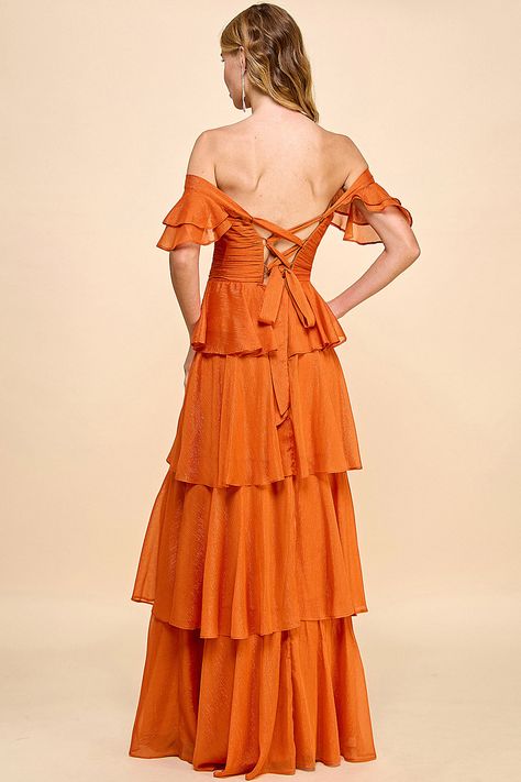 The Clementine Maxi Dress, is a stunning choice that combines sophistication and charm. This dress features a ruffle-layered design that adds texture and movement, along with a tie-back closure for an adjustable fit. The V-notch scrunch bodice enhances the dress's visual appeal, creating a flattering and feminine shape. Crafted from shimmering fabric, the Clementine Maxi Dress catches the light beautifully, adding a touch of glamour to your look. The tiered, floor-length skirt flows gracefully w Understated Glamour, Bachelorette Party Dress, Champagne Dress, Rehearsal Dinner Dresses, Flowy Design, Rehearsal Dress, Floor Length Skirt, Romantic Evening, Maxi Dress Wedding