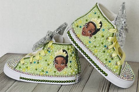 Princess Tiana Custom Converse, Little Kids Shoe Size 10-2 Information about the shoes All sneakers are Converse brand and have a mix of hand applied high quality glass crystals and resin flat-backs. Please select your color choice by the available drop down options, an option of all glass crystals no color is also available. Converse sizing is unique and sneaker specific. Converse Kids Chuck Taylor All Star Sneakers are expected to run a half-size large. Custom Orders are also available and alw Princess Tiana Costume Toddler, Princess Tiana Custom Shoes, Tiana Princess Birthday Party, Princess Tiana Shoes, Princess Tiana First Birthday Party, Princess Tiana Birthday Party Ideas, Princess And The Frog Birthday Party, Princess Tiana Sweet 16 Ideas, Tiana Party