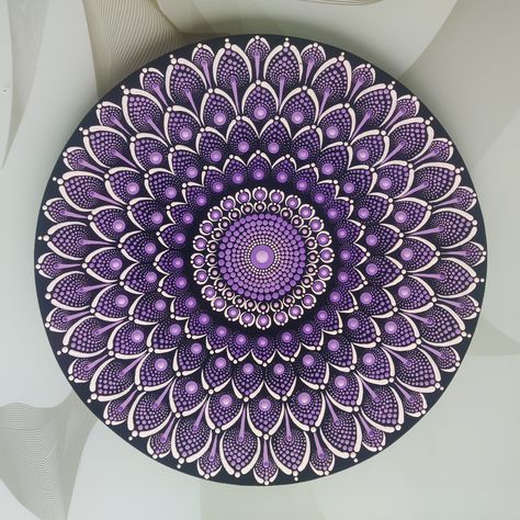 🔴  Dot Mandala painting  👋  Handmade  🟤  12 inch round Birchwood canvas 🎨  Acrylic colours  🤍  Sealed with varnish  🌍  Ships worldwide from India🇮🇳 🏠  Perfect addition to your home 🎁  Ideal for gifting also This Dot Mandala painting is made on a 12 inch round  canvas made of Birchwood. Different shades of mauve, purple and white colour are used to create this piece.The product is sealed with varnish for  better protection.This piece will instantly enhance the beauty of your living space. Mandalas are a symbol of spritual guidance and are excellent if you want to create a sacred , positive place. Not only they promote peace and internal growth but they also make stunning decor They can elevate your living space in the blink of an eye.They are also regarded as a symbol of fortune,l Purple Dot Mandala, Mandala Dot Painting Canvas, Colour Mandala, Dot Mandala Painting, Dot Mandala Art, Mauve Colour, Oil Pastel Drawings Easy, Mandala Wall Decor, Mandala Painted Rocks