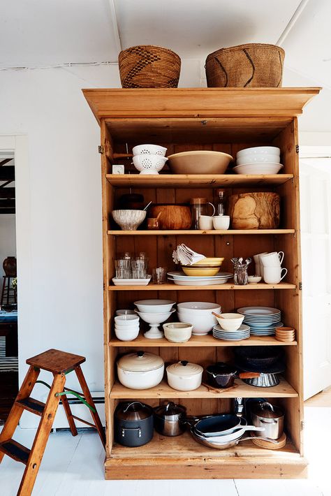 Glenn brought in a large bookcase for more storage in the kitchen. &#8 East Hampton Houses, Hamptons Cottage, Antique Wooden Chairs, Saarinen Table, Wooden Beams Ceiling, Large Bookcase, Organized Home, Hamptons House, East Hampton