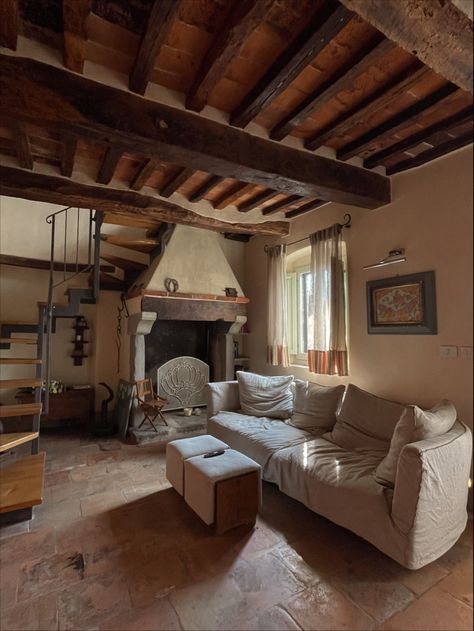 Picture of a tuscan living room which has linen couch, old fireplace, old beams on the ceiling, tile floors Old Italian House Aesthetic, Countryside Interior Design, Interior Design Cottagecore, Italian Countryside House Interior, Northern Italy House Interior, Rustic Italian Living Room, Old Italian Aesthetic House, Italian Home Interior, Italian Homes Interiors