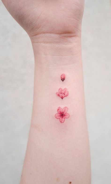 Cute Tattoos Red Ink, Pink Tattoo Aesthetic Small, Sakura Petal Tattoo, Sakura Small Tattoo, Pink Small Tattoos, Pink Color Tattoo, Pink Flower Tattoo Small, Blossoming Flower Tattoo, Small Pink Tattoo