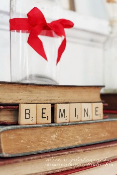 This simple, scrabble Valentine vignette proves that you don't need elaborate decor to be festive. I love the old books and one, red ribbon. Adorable! #simplevalentinevignette #valentinevignetteideas #scrabbletiledecoratingideas #diyvalentinedecoratingideas #valentinesdaydecoratingideas #farmhousevalentineideas #decoratewithbooks Valentine Mantel Ideas, Valentine Vignette, Valentine Mantel, Selamat Hari Valentine, Mantel Ideas, Happy Hearts Day, Scrabble Letters, Vintage Valentine, Valentine's Day Quotes