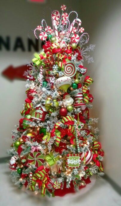 My tree at the office! Red, lime green, white...candy, flocked tree, candy cane, snowflakes Red White And Lime Green Christmas Decor, Flocked Tree With Red And Green, Flocked Grinch Christmas Tree, Red White And Lime Green Christmas Tree, Red And Bright Green Christmas Tree, Red And Lime Green Christmas Tree, Red And Green Flocked Christmas Tree, Red White And Green Christmas Decor, Red Green And White Christmas Tree