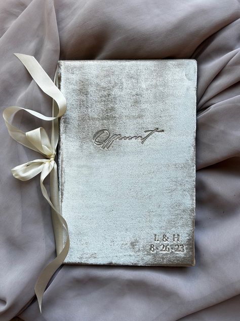 "Our Velvet Officiant Book / Wedding Officiant Notebook Gift is the perfect Wedding Officiant Keepsake. Our officiant books are a classy way for your officiant to hold notes, program and other keepsakes at the altar.  Available in gray, champagne (beige), white, black, peach, emerald and wine velvet.   With the ribbon-cornered sides, the couple's vows can be held securely on each side (holds 8 1/2 x 5 1/2\" sheets). With the center ribbon binding (optional), the vows, officiant's order of servic Officiant Book, Ribbon Binding, Officiant Gift, Notebook Gift, Vow Book, Order Of Service, Book Wedding, Black Peach, Notebook Gifts