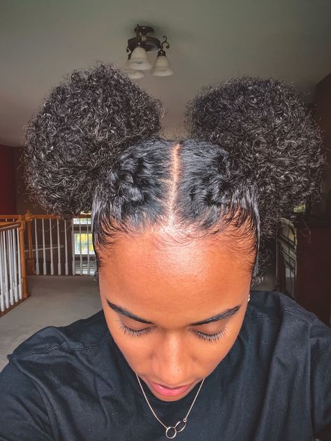 The Best Afro Hair Bun Looks This Year Space Bun Natural Hair, 2 Braids Into Bun Black Hair, 2 Buns On Natural Hair, Space Buns Coily Hair, Braided Space Buns Black Women, Space Buns Black Women, Two Buns Hairstyle Black Natural Hair, Space Buns Curly Hair, Two Space Buns