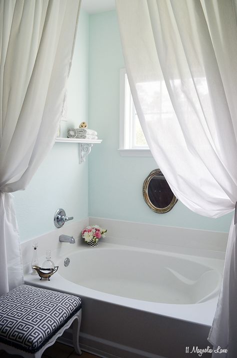 beautiful bath! i love the little things sitting out (flowers, the glass holders + the white curtains really soften it and the old gold mirror ads a bit of chic to it :) also like the aqua colored walls. Tub Ideas, Spa Like Bathroom, Bathroom Tub, Garden Tub, Bathroom Windows, Trendy Bathroom, Bathroom Spa, White Rooms, Bath Room