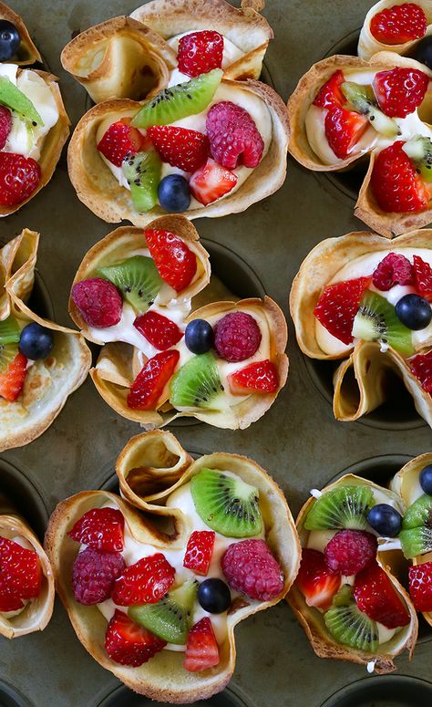 Fruit Filled Lemon Crepes with Coconut Whipped Cream - Muffin tin lemon crepes filled with homemade coconut whipped cream topping. Garnished with fresh fruit and powdered sugar. Serve for breakfast, brunch or dessert. Crepe Decorations, Fruit And Cream Cheese Pastries, Lemon Crepes Filling, Crepe Fruit Filling, Crêpe Party, Crepe With Strawberries, Lemon Crepe, Berries And Cream Crepes, Fruit Crepes