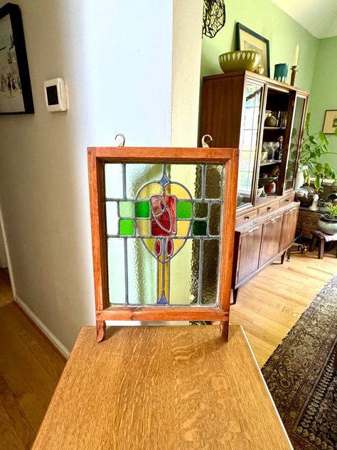 Antique stained glass framed panel  ~ Leaded glass  ~ Thick wood frame  ~ Floral design with wonderful colors and textured glass  ~ Brass hooks for hanging  ~ These panels came from England in the late 1800's early 1900's  ~ Frames have been refinished  ~ I have many from this estate available in the shop  ~ Excellent used antique condition  Measurements  ~ 16" long x 23" tall x 1 1/2" thick ----------------------------------------------------------  Convo for INTERNATIONAL SHIPPING QUOTES ~ Always Happy To Ship Anywhere  Please See Shop Policies Prior To Purchase  ---------------------------------------------------------- Stop By The Shop - www.etsy.com/shop/RustynailSalvageCo Visit Our Sister Shop for Vintage Threads- www.etsy.com/shop/ArsenicandOldLacevtg ------------------------------- Stained Glass Frames, Antique Stained Glass Windows, Leaded Glass Door, Stained Glass Studio, Frame Floral, Brass Hooks, Antique Stain, Glass Diy, Panels Wall