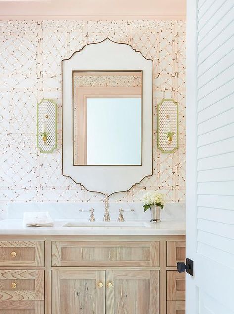 Gray wash oak washstand with black and white Moroccan style mirror flanked by green flower sconces atop pink bamboo lattice wallpaper in a transitional bathroom. Glam Pad, Powder Room Design, Transitional Bathroom, Subway Tiles, Powder Rooms, Shower Drain, Framed Photographs, Chic Bedroom, Closet Space