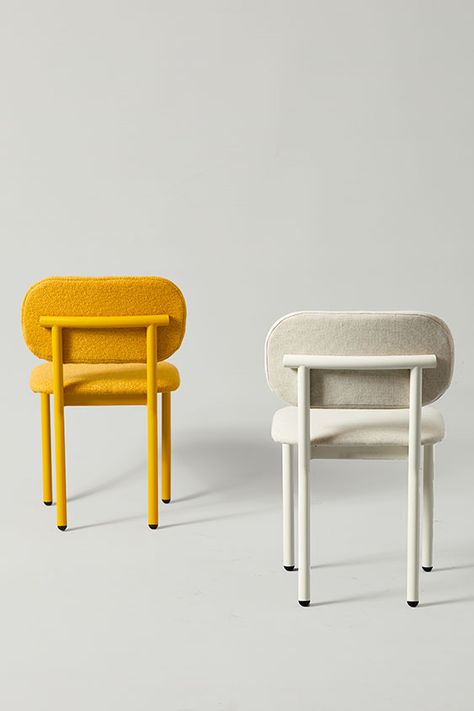 Two modern restaurant dining chairs against a grey background. The first chair is in a honey yellow finish with matching boucle fabric, and the other is in an off-white finish with light grey fabric. Made-to-order and produced in America. The Ferdinand Chair. Design Chair Modern, Sturdy Dining Chairs, Cool Dining Chairs, Cafe Chair Design, Color Dining Chairs, Bar Chair Design, Colorful Dining Chairs, Dining Chair Ideas, Restaurant Chairs Design