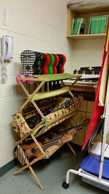 Homemade ukulele storage rack using a clothes drying rack, fabric, pool noodles, velcro, batting, foam Ukulele Storage, Music Room Storage, Teaching Ukulele, Instrument Storage, Guitar Storage, Kayak Storage Rack, Cool Ukulele, Music Storage, Middle School Music