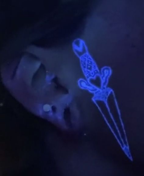 Glow in the dark face dagger tattoo Invisible Ink Tattoo Black Lights, Black Light Face Tattoo, Uv Face Tattoo, Uv Light Tattoo, Blacklight Tattoo, Pretty Face Tattoos, Glow In The Dark Tattoo, Uv Ink Tattoos, Teen Tattoos