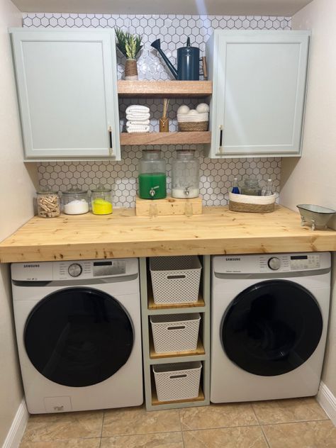 Hi Pinteresters!! I hope you like my new laundry room! All made by yours truly. Custom made washer and dryer cover. Custom center shelves. Custom storage cubby. All the glassware is from Walmart (super cheap). The plastice storage baskets are from Home Centric, as well as the rope decor and the mini bathtub. The cabinets are from Home Depot. Bought them unfinished and painted them with Shermin Williams Sea Salt from Lowe’s. Wall color is SW Divine White. Laundry Room Cabinet Shelves, Cube Storage Between Washer And Dryer, Washer And Dryer Cover, Small Cabinet Between Washer And Dryer, Diy Shelves Over Washer And Dryer, Shelves Above Washer And Dryer, Wood Shelf Above Washer And Dryer, Diy Shelves Above Washer And Dryer, Washer And Dryer Covers