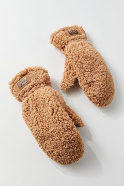 Fuzzy and warm, these faux Sherpa mittens keep fingers happy and spirits high during cold winter weather. Finished with leather trim and a conductive textile palm. Cinched wrist with an UGG logo patch. Content + Care. Polyester, leather, elastane Spot clean ImportedSize. S/M circumference: 6”-7” L/XL circumference: 7”-8” Sherpa Mittens, Ugg Mittens, Shop Accessories, Winter Weather, Accessories Bags, Womens Uggs, Cold Winter, Accessories For Women, Christmas List