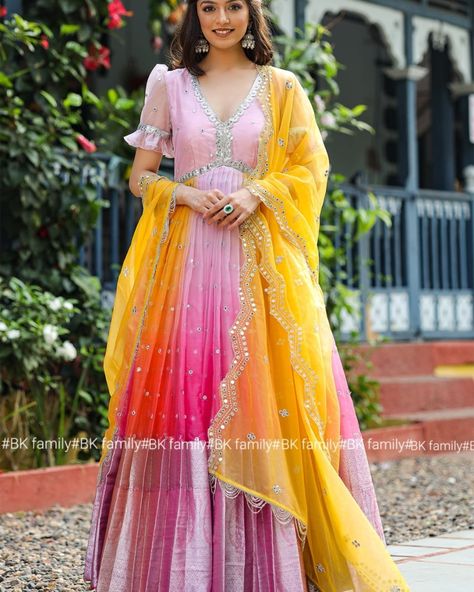 Crafted from the finest Organza, our Rangeen Anarkali dress enchants with its ombré shades of pink and orange. It features balloon sleeves and a V-neck. Embellished with mirror work, this set transcends time and exudes ethereal charm. Pair it with the yellow dupatta to complete the look. Dupatta was also available in Orange Color. (Side zip attached) Code- BK717N Name- Rangeen Anarkali Dress Size- S to XL Dress Fabric-Organza Dress Length- 53inches Color- Pink, Orange & Yellow Price- 3350/-F... Long Gown Dress From Saree, Party Wear Gowns Indian, Organza Anarkali Dress, Long Gown With Dupatta, Anarkali Party Wear, Anarkali Dress Indian, Gowns Indian, Couple Dresses, Yellow Dupatta