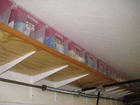 Shelving Above Garage Door, Garage Shelf Brackets, Storage Over Garage Door, Garage Shelf With Sliding Doors, Over The Garage Door Storage, Over Garage Door Storage, Above Garage Door Storage, Storage Above Garage, Garage Door Storage