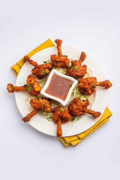 Photo chicken lollipop is indian chinese... | Premium Photo #Freepik #photo #chicken-lollipop #chicken-dish #appetizer #fried-food Chicken Lollipop Plating, Chicken Lollipop Photography, Lollipop Chicken, Chicken Lollipop, Chinese Appetizers, Masterchef Recipes, Chicken Lollipops, Plating Ideas, Snack Shop