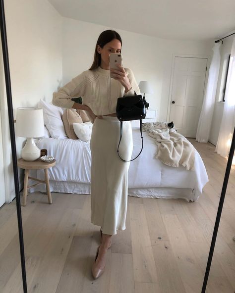 Tyler | Casual Style on Instagram: “A New Year’s Eve outfit idea that still feels like pajamas. ✨ I’ll always love a silky midi skirt paired with chunky knits. white midi skirt, ivory midi skirt with white sweater, silk midi skirt with sweater outfit, cream silk midi skirt, satin midi skirt outfits, how to wear silk midi skirt with flats, polene numero un nano noir, polene paris nano, polene paris bag noir, bedroom decor #poleneparis women’s outfits, women’s style, outfit ideas, parisian outfits Midi Skirt With Sweater Outfit, Midi Skirt With Sweater, Slip Dress Sweater, Noir Bedroom, Dress Sweater Outfit, Satin Midi Skirt Outfits, Skirt With Sweater Outfit, Polene Paris Bag, White Satin Skirt