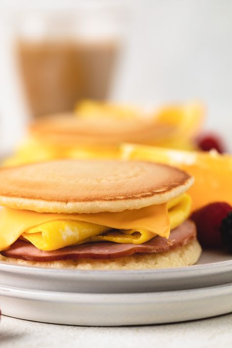 Our Pancake Sliders are a sweet and savory breakfast made with ham, eggs, and cheese sandwiched between two fluffy pancakes. This recipe is kid-friendly and perfect for breakfast, brunch, or as a fun snack! Pancake Egg Sandwich, Pancake Sliders, Easy Strawberry Banana Smoothie, Sweet And Savory Breakfast, Pineapple Coconut Smoothie, Eggs And Cheese, Banana Breakfast Smoothie, Mango Pineapple Smoothie, Cranberry Orange Muffins