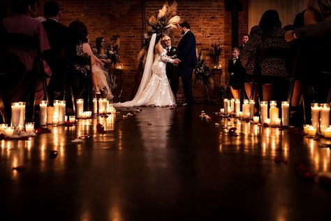 candle-lit wedding ceremony at Brick & Mortar events with backdrop made by friends and family of the couple Candlelight Wedding Ceremony Outdoors, Night Wedding Ceremony Indoor, Candle Lit Ceremony Aisle, Dim Lit Wedding Ceremony, Indoor Candlelight Wedding, Candle Lit Isle Wedding, Candle Lite Wedding Ceremony, Candle Lit Weddings, Bridesmaids Holding Candles