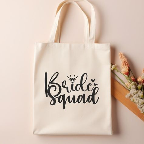 Get your Bride Squad ready in style with our Bride Squad Tote Bag! Perfect for bridesmaids, this tote bag is an essential accessory for any bachelorette party or wedding celebration. Use it as a bridesmaid gift bag or a special touch for your bridesmaid proposal. With its chic design, this tote bag is not just practical but also a keepsake for your bridal party to remember your special day. It's the ideal bachelorette gift that combines fun and function for your closest friends! Bachelorette Party Tote Bags, Bridal Party Gift Bag, Bachelorette Tote, Bridesmaid Tote Bags, Bachelorette Gift, Bridesmaid Gift Bags, Bride Squad, Bachelorette Gifts, Bags Aesthetic