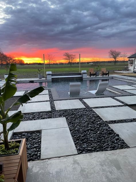 Dark River Rock Landscaping, Rock Around Pool, Pavers With Rocks In Between, Black Rock Landscaping, Pervious Pavers, Rock Scaping, Landscape Design Backyard, Backyard With Pool, Dark Grey Houses