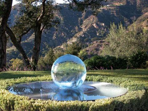 A hidden pump sends gentle streams of water down the sides of the 2-foot-tall Aqualens acrylic sphere, which then pools in a 5-foot-wide steel dish. The sphere can also be illuminated. (allisonarmour.us) Outdoor Water Features, Fountains Backyard, Pool Water Features, Fountain Design, Deco Nature, Moon Garden, Water Features In The Garden, Garden Fountain, Fountains Outdoor