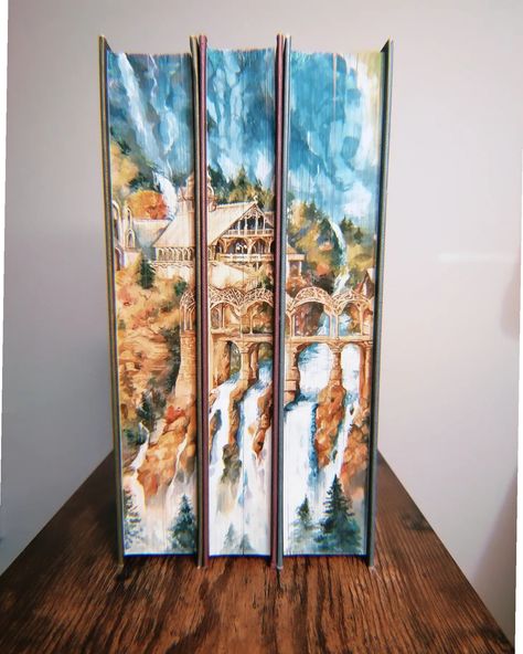 Watercolour fore-edge painting of Rivendell on new Waterstones edition of the Lord of the Rings books! I spent years mostly painting digitally, and I don't even remember when was the last time I painted something that's NOT a portrait, so I went through a lot of weird stages emotionally with this one 😂 Christmas gift for @impalei3 🧚‍♂️ 🧙‍♂️ #lotr #foreedgepainting #bookart #lordoftherings #bookseries #books #bookedges #bookedgepainting #weroni #bookstagram Book Edge Art, Painted Book Covers, Lord Of The Rings Painting, Book Edge Painting, Lord Of The Rings Books, Fore Edge Painting, Book Edges, Bible Painting, Book Painting